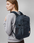 woman carrying navy Fjällräven backpack