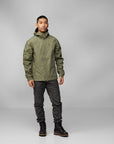man wearing green windbreaker jacket and black trekking trousers