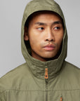 man wearing green windbreaker jacket with a hood