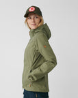 woman wearing green jacket with hood and green cap