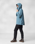 woman wearing dawn blue waterproof rain jacket with hood