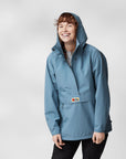 woman wearing blue waterproof rain jacket with Fjällräven logo