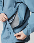 dawn blue waterproof rain jacket with opened zip pocket