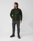 man in dark green fleece jacket and grey trouseres