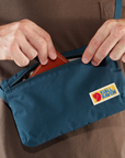 putting card holder inside navy waist pouch small bag with Fjällräven logo