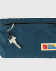 key strap inside a zip opening of navy pouch small bag with Fjällräven logo