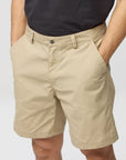 Beige shorts worn by a person on a plain background