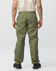 Person wearing green pants on a white background