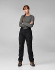 woman wearing grey long sleeve top and black long trekking trousers with pockets