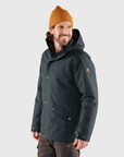 man in black windbreaker jacket with orange beanie