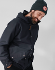 man in black windbreaker jacket with hood with black beanie