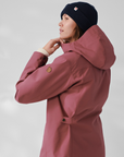 woman in red puffer long jacket with hoodie