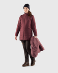 woman in red puffer long jacket and brown trousers