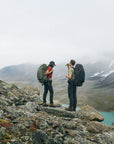 two men taking a break while trekking on mountain