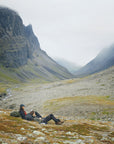 two men taking a break while trekking on the mountain