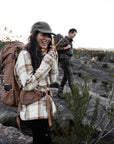 couple in long sleeve shirt hiking on rocky mountain