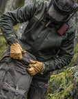 Person in outdoor gear with a backpack in a forest setting