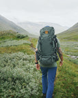 men carrying trekking backpack trekking along mountain