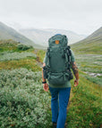 a men carrying trekking backpack trekking on a mountain