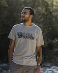 man wearing fossil round neck t-shirt on a rocky mountain
