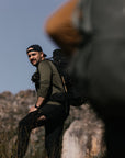man in laurel green winter long john trekking on mountain