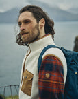 man wearing white vest over a checkered shirt