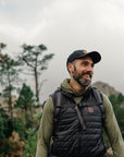 man wearing green sweater hoodie with black vest
