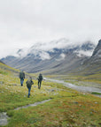 three men trekking on a mountain