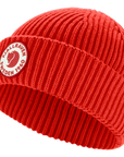 Red knit beanie with a Fjällräven logo on a white background