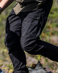 Person wearing black pants in a natural setting