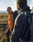 two men doing a hiking trip on grass surface