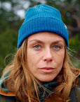 woman wearing indigo blue beanie with Fjällräven logo