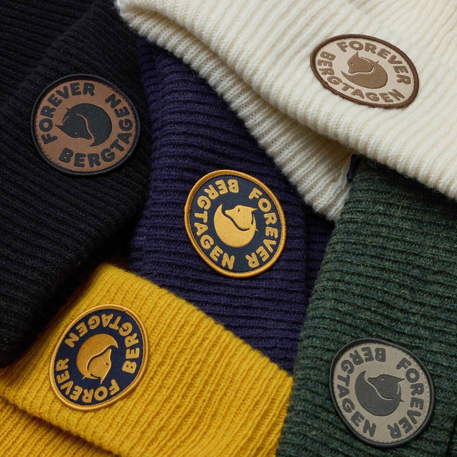 Collection of beanies in various colors with 'Forever Bergtagen' logo.
