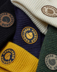 Collection of beanies in various colors with 'Forever Bergtagen' logo.
