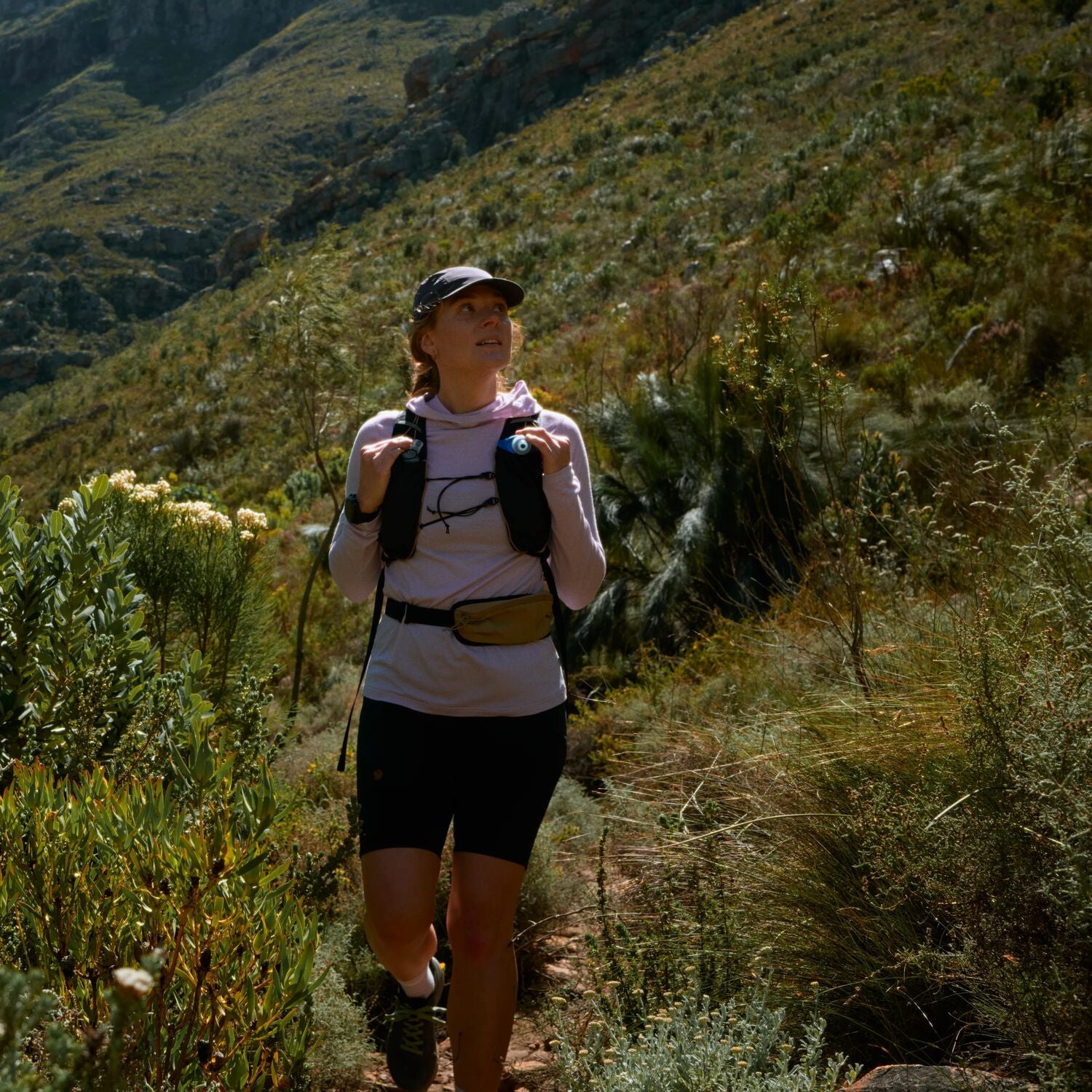 Person hiking on a trail in a mountainous area