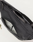 Black sling bag with a key attached on a white background