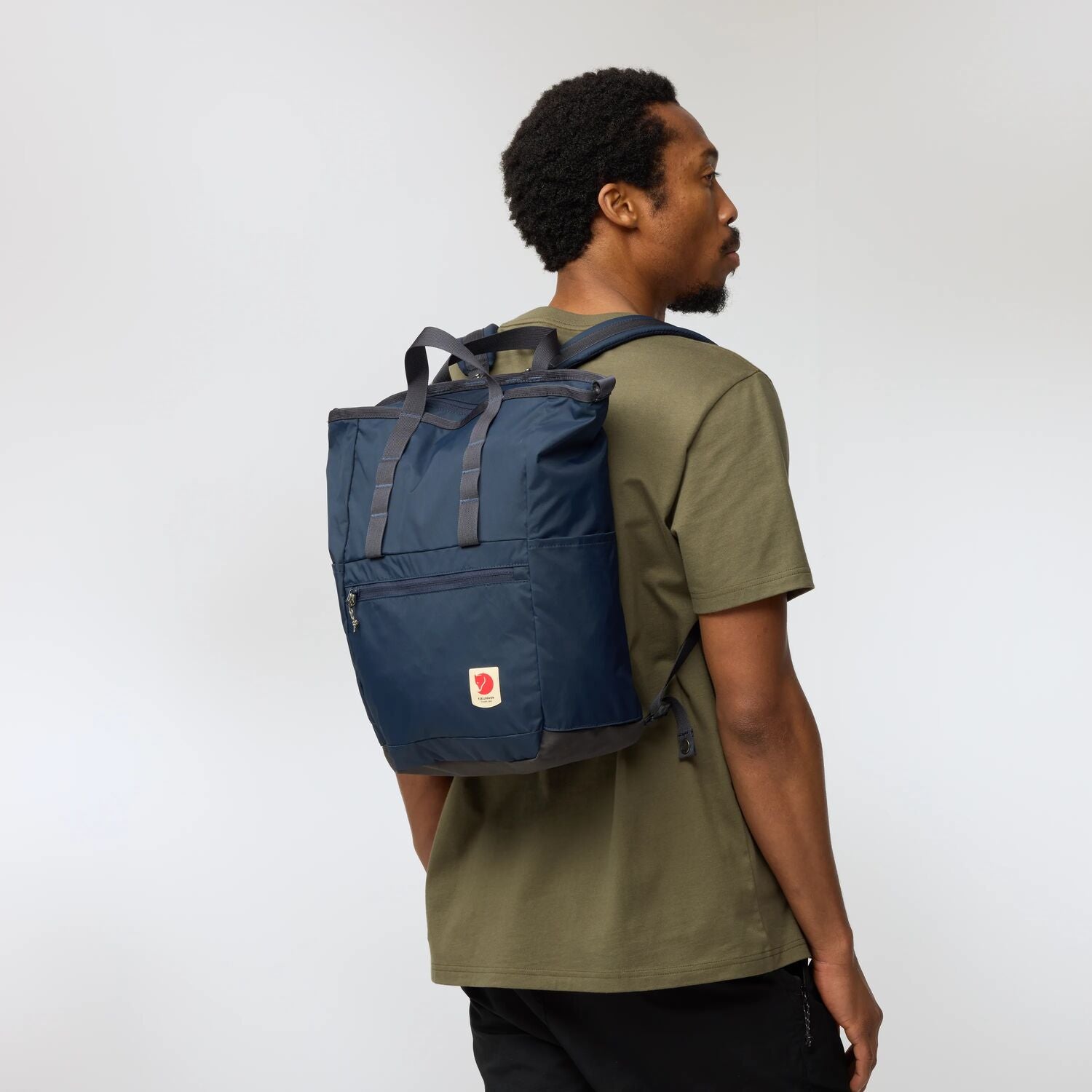 Man wearing a blue backpack on a white background
