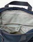Open blue backpack with beige interior on a white background