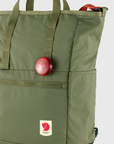 Green backpack with a red light and visible brand logo on a white background