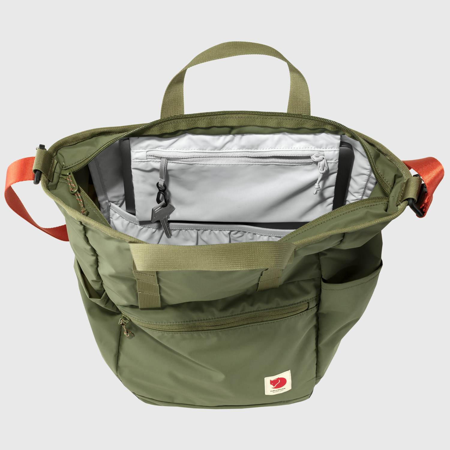 Green backpack totepack with red accents on a light gray background