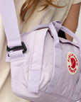 Light purple backpack with Fjällräven Kånken logo on a neutral background