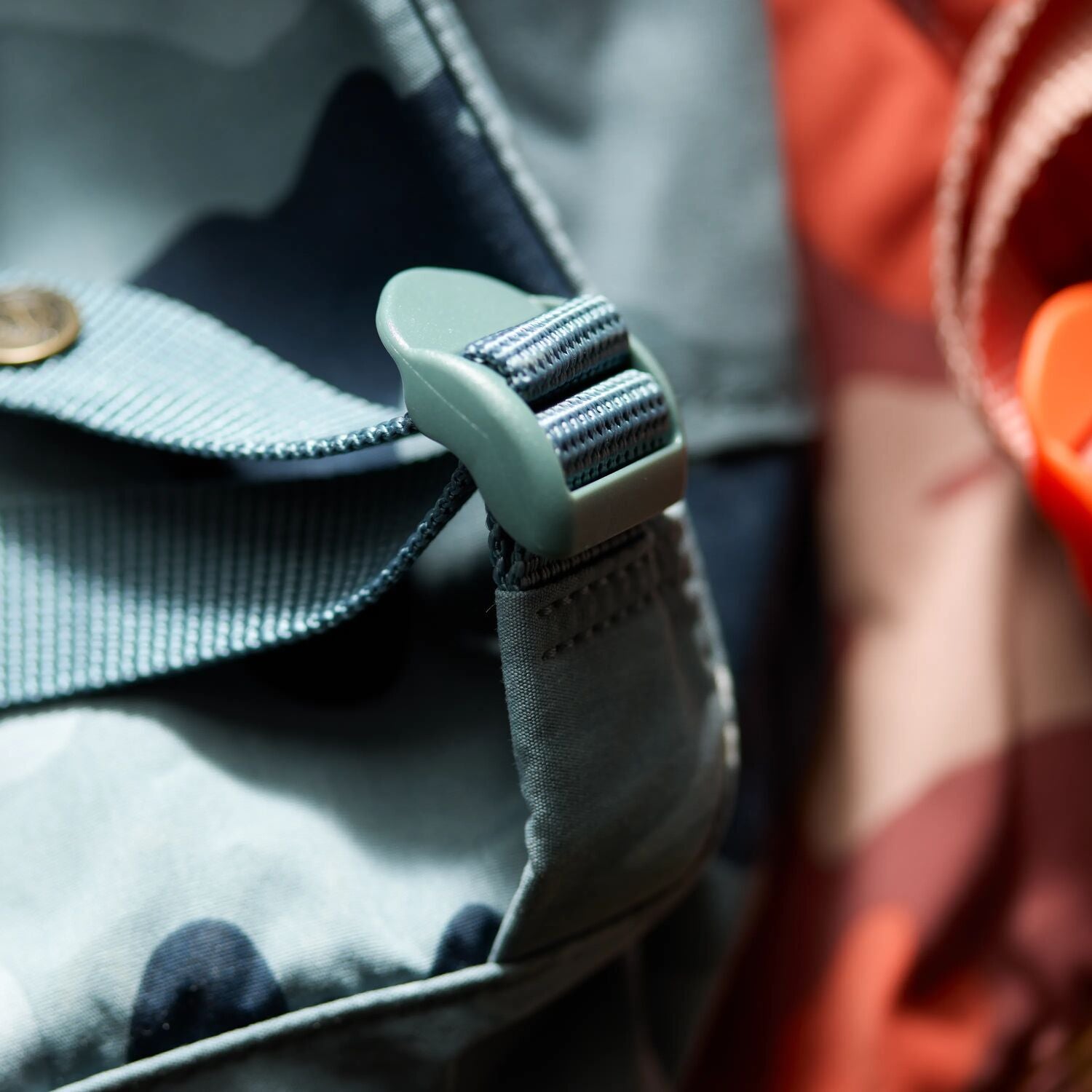 Close-up of a green belt buckle on a bag
