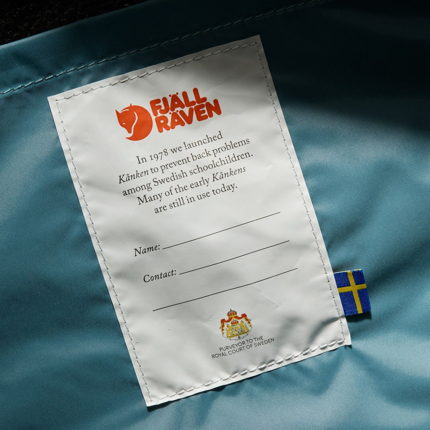 Fjällräven label on a blue fabric background