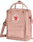 Pink sling bag with Fjällräven Kånken logo on a white background