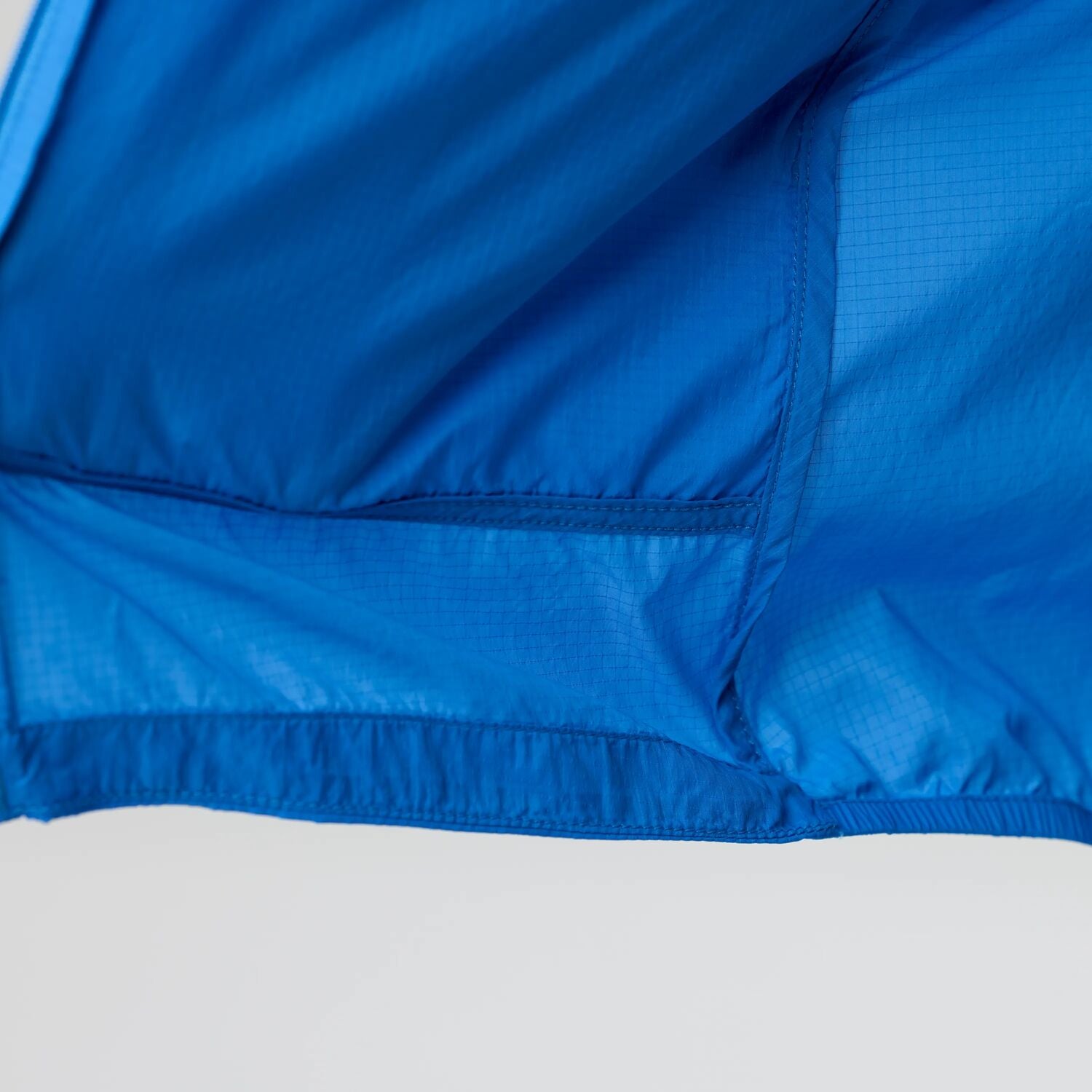 Close-up of a blue jacket with a white background