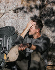 man in basalt winter long john resting on mountain