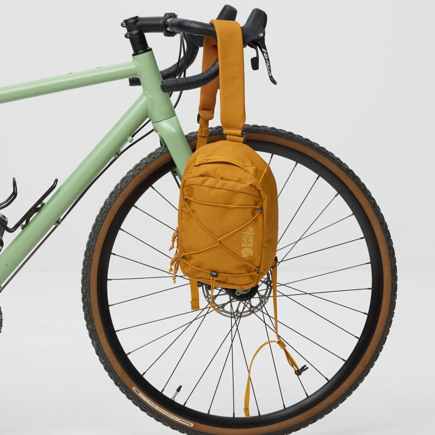 Yellow sling bag attached to a bicycle on a white background