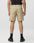 Person wearing beige shorts on a plain background