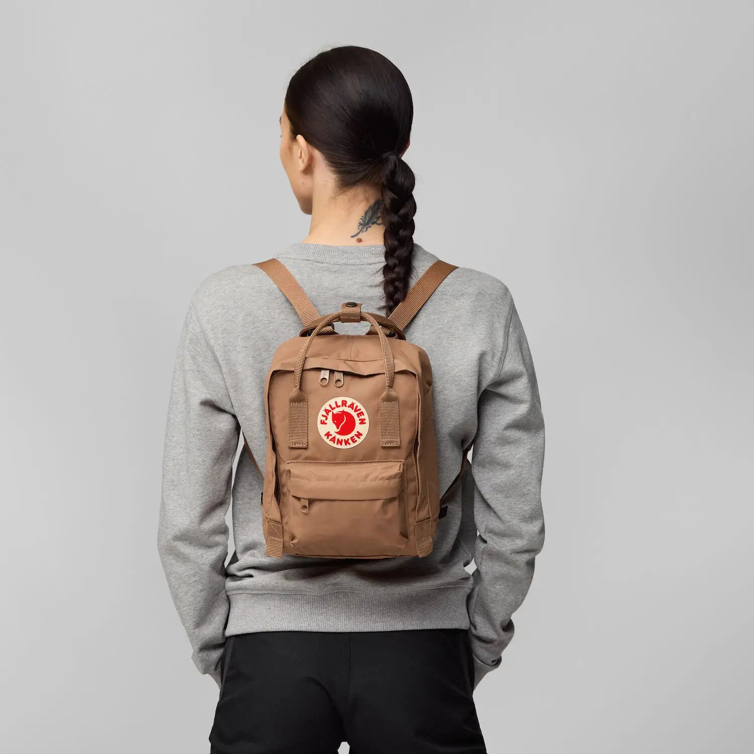 woman carrying Kanken mini backpack