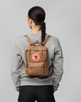 woman carrying Kanken mini backpack